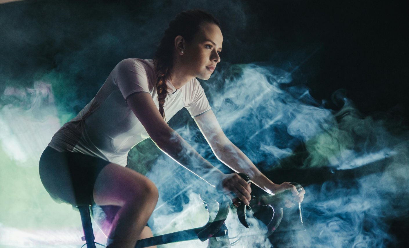 A woman on a bike, taking part in a race after one to one coaching by Alpha State