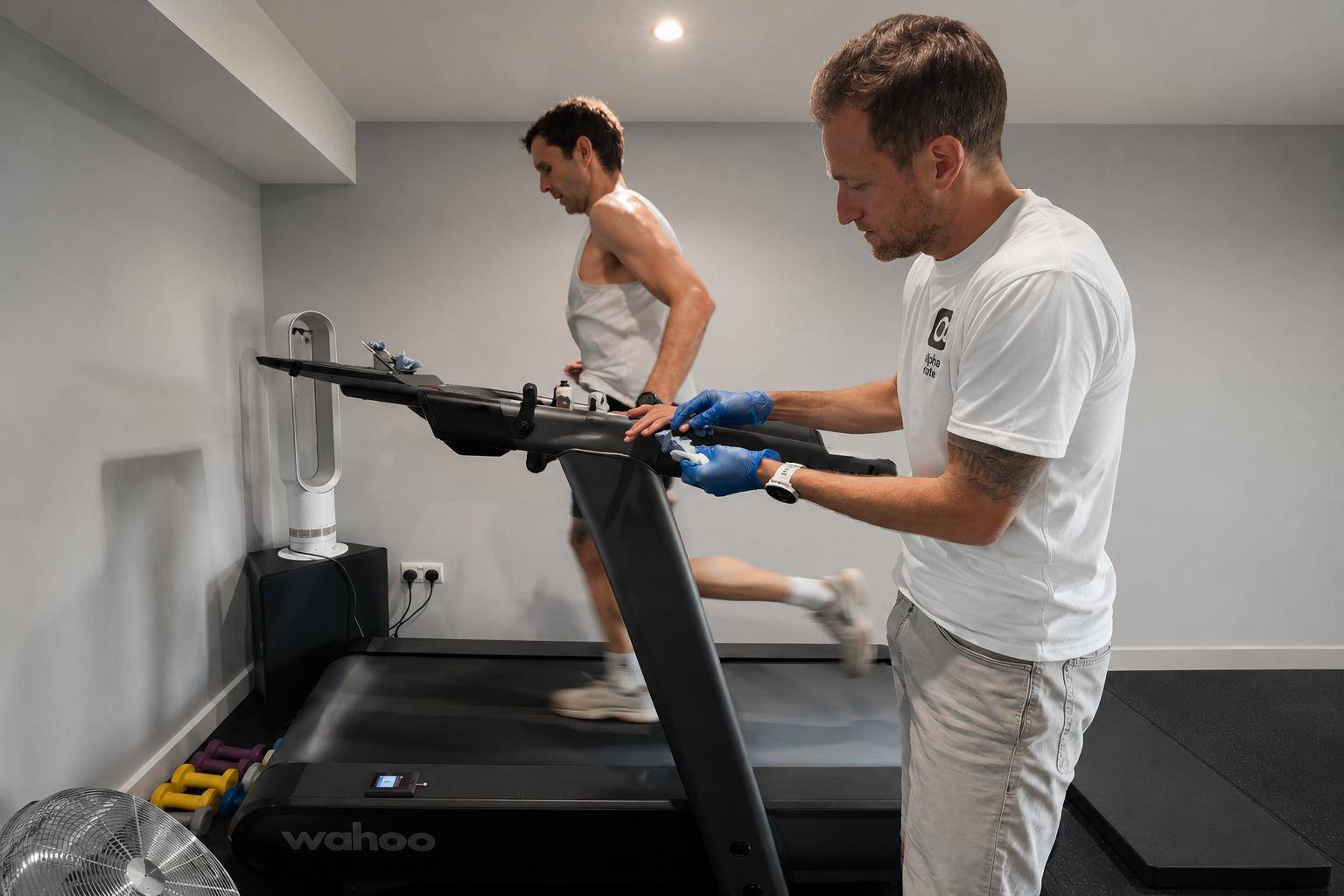 A woman on a treadmill, hooked up to a breathing analyser during one-to-one coaching