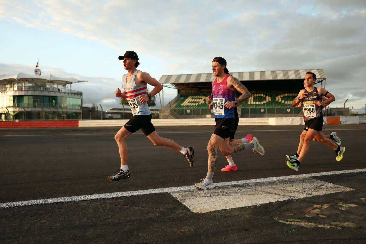 A man celebrating completing a triathlon after one to one coaching by Alpha State
